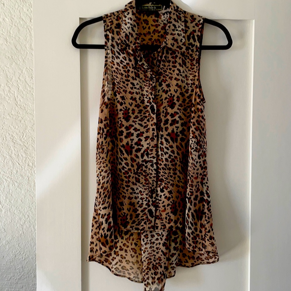 Sleeveless blouse with cut button detail on back.